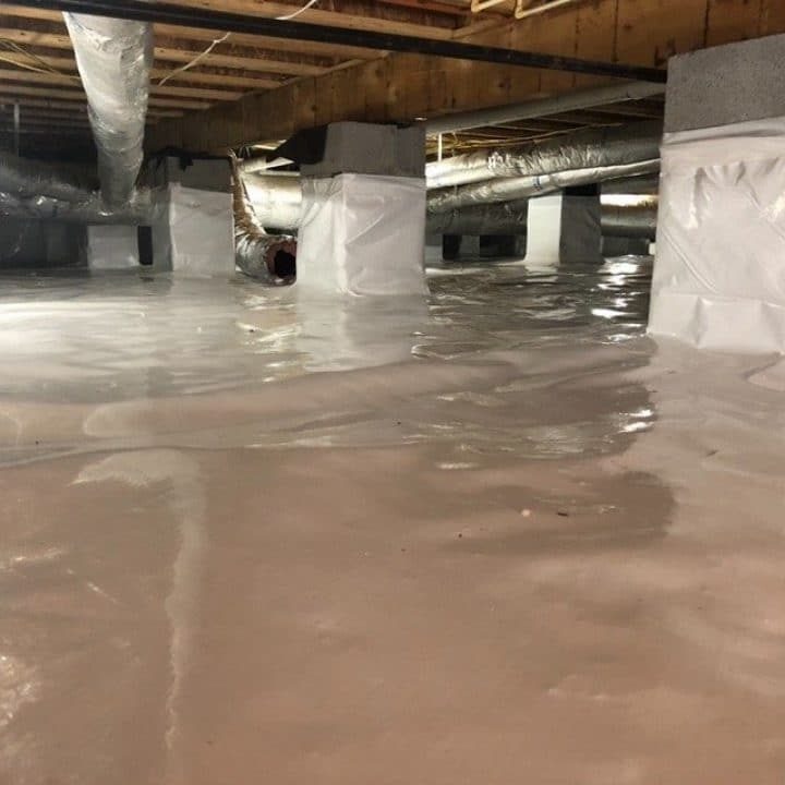 Crawl space in Huntsville AL home with sleek vapor barrier after comprehensive encapsulation services by United Pest and Turf